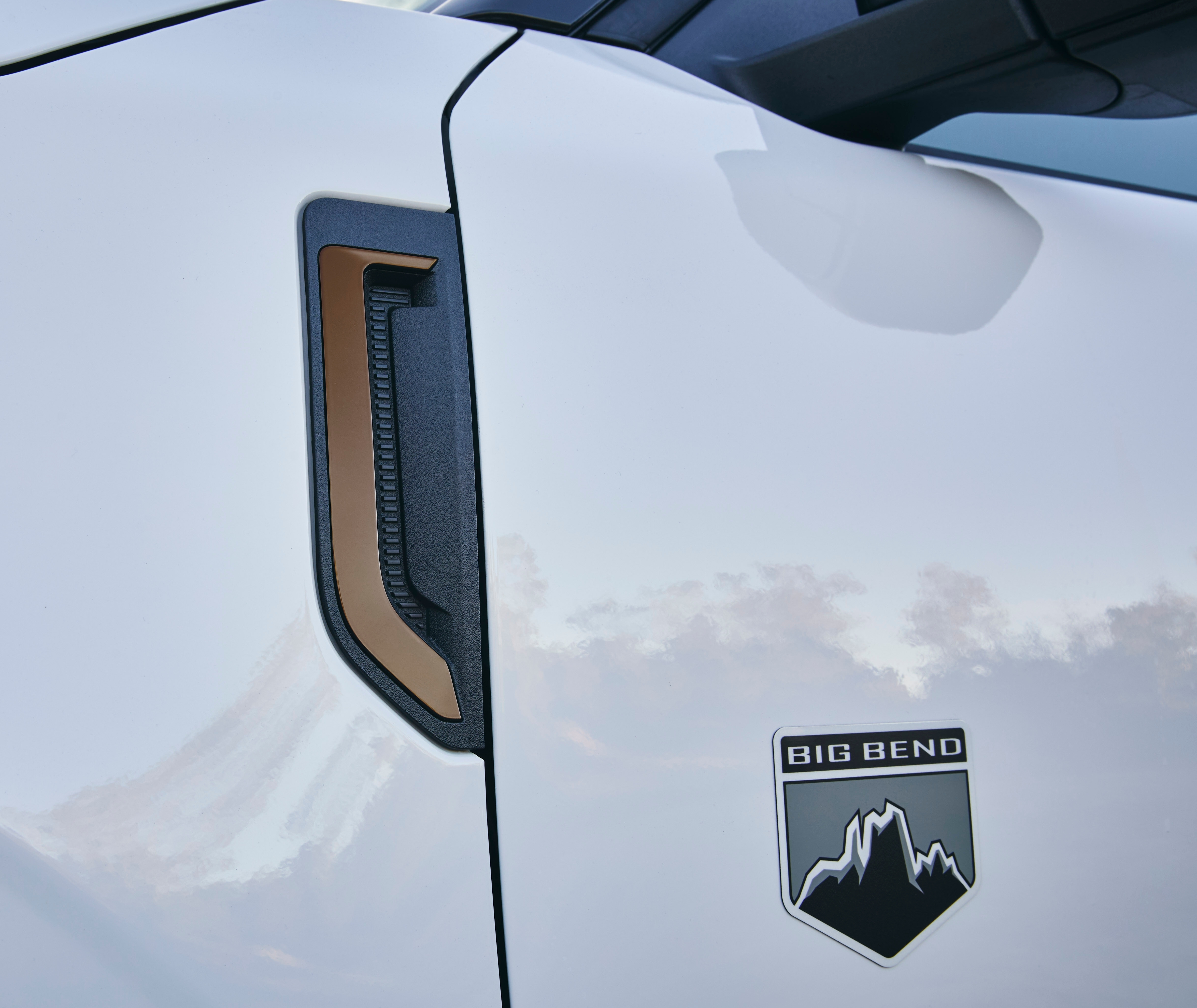 The driver's side of a white Bronco Sport shows copper detail and a badge that says "Big Bend."